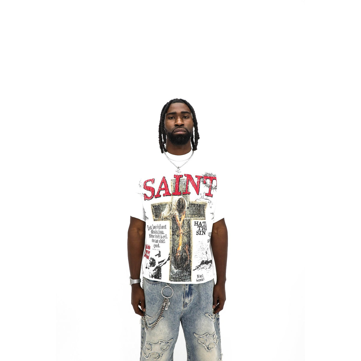 Saint tee, front — red SAINT headline over a cross collage on white, cut sleeves