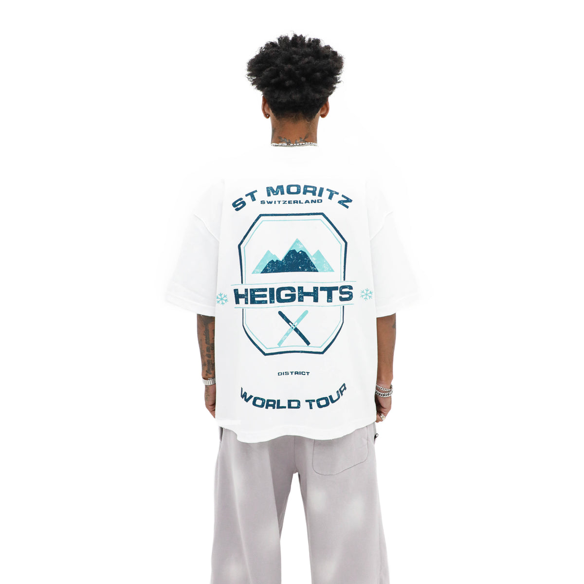 St. Moritz white resort tee — back view with navy and aqua mountain and ski graphics