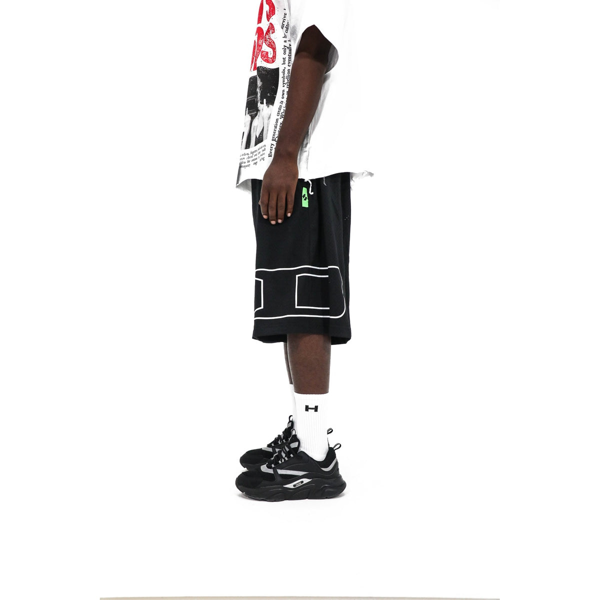 Heights Outline Logo Shorts, detail — green logo tab at the side seam