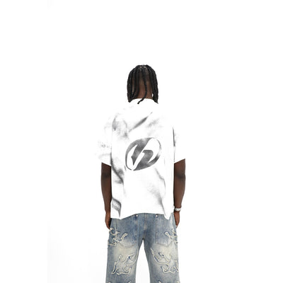 Heights Daily News tee, back — hand-sprayed circle-H stencil with overspray on white