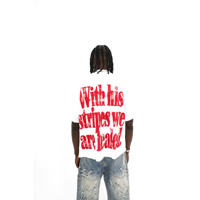 Saint tee, back detail — raw cut hem and distressed red lettering