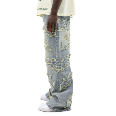 HeightsDistrict Inferno distressed denim jeans with ripped details and faded wash on a model's legs.