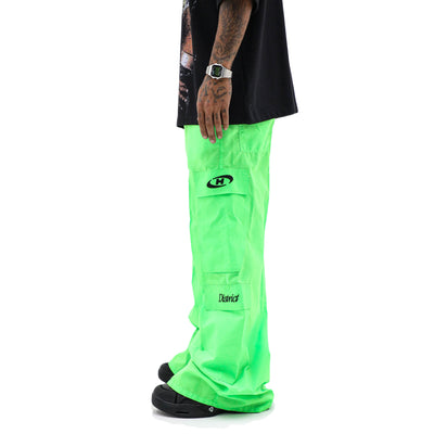 Neon parachute cargo pants by HeightsDistrict featuring bright neon fabric, multiple pockets, and a relaxed fit for casual wear.