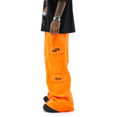 Neon parachute cargo pants by HeightsDistrict featuring bright neon fabric, relaxed fit, and multiple cargo pockets.