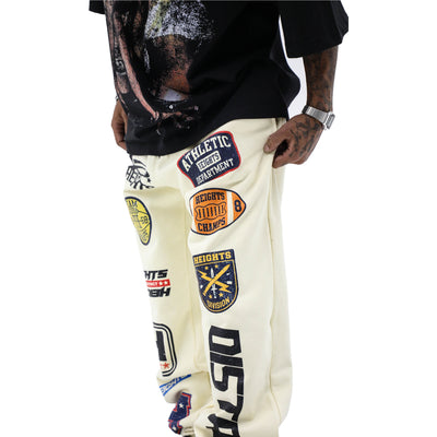 HeightsDistrict varsity jogger pants in black with white side stripes, relaxed fit, and elastic waistband.