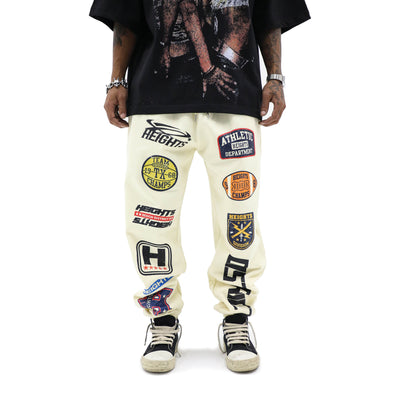 HeightsDistrict varsity joggers in black, slim-fit pants with elastic waistband and cuffed ankles, casual athletic style.
