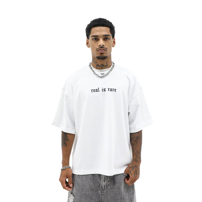 Black "Real is Rare" T-shirt by HeightsDistrict featuring bold white text on the front, casual fit, and soft cotton fabric.