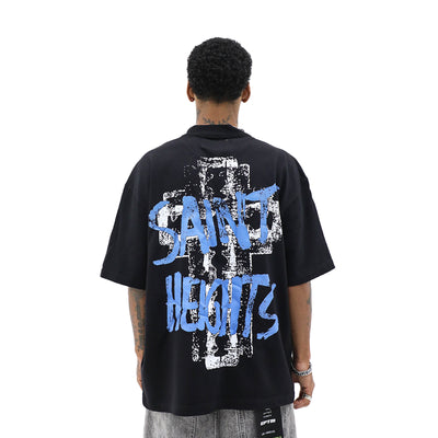 Saint Heights May God Bless You T-shirt with inspirational text in white on a black fabric background.