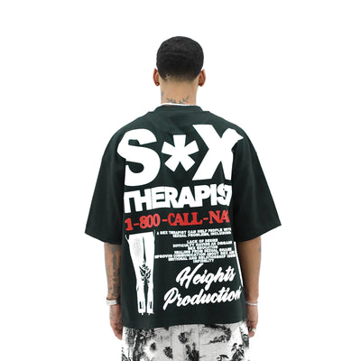 A white T-shirt from HeightsDistrict featuring the bold graphic design of "The Sex Therapist" logo on the front.