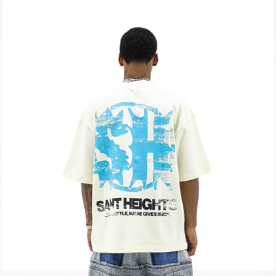 HeightsDistrict Saint Heights Cream T-shirt featuring a stylish graphic design on soft, comfortable fabric.