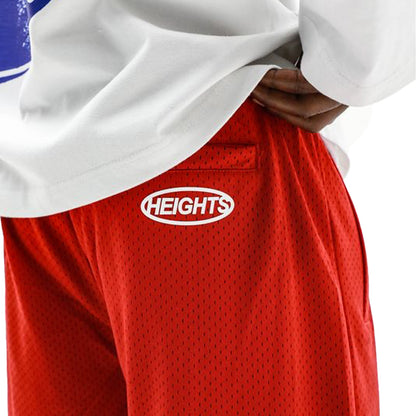 HeightsDistrict Flame Mesh Shorts in vibrant red and black with a breathable mesh design, styled with an elastic waistband.